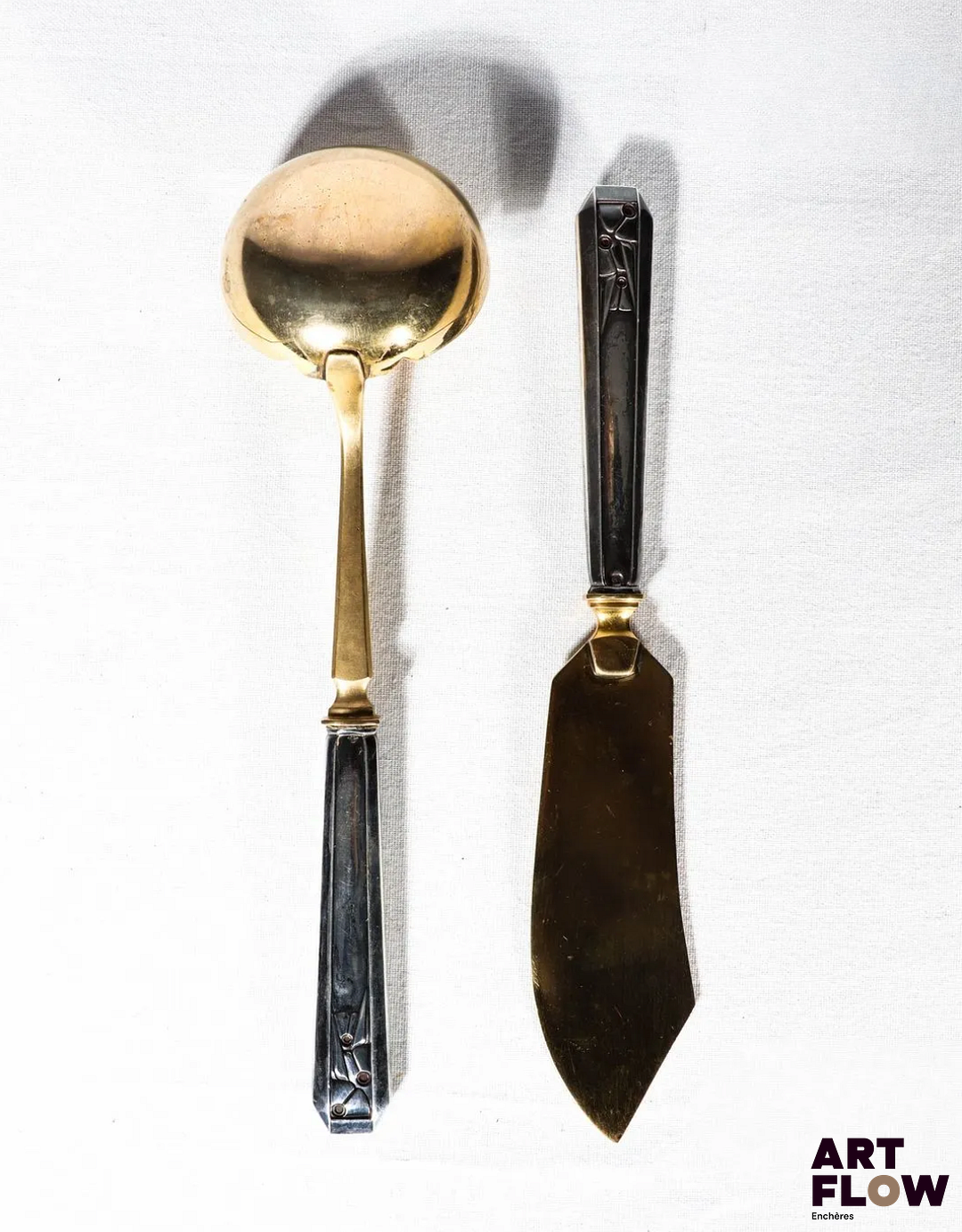 Couverts de service à décor de style Art Deco. Argent fourré et vermeil. Poinçon Minerve 1er titre, poinçon d'orfèvre Ernest Prost Insculpé le 23 août 1923 et biffé le 2 février 1963, 7 rue de Réaumur, Paris. Poids total 234,48 g Bon état général malgré quelques légers défauts (oxydations)