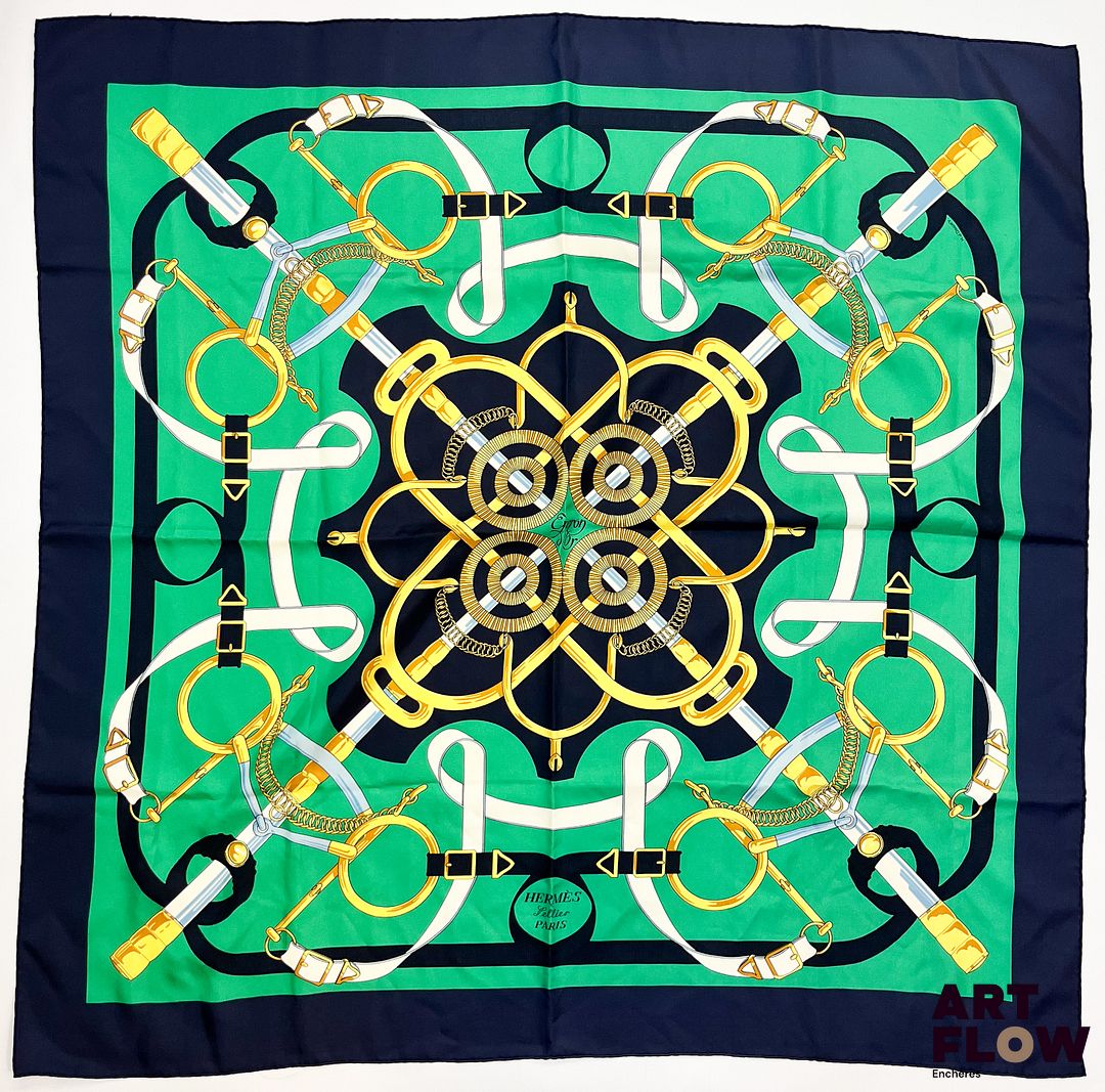 HERMÈS Modèle "Eperons d'or" d'après un dessin d'Henri d'Origny Carré en twill de soie dans les tons vert à bordure bleu marine. 90 x 90 cm Petite tâche et fil tiré. Bibliographie : Genevieve Fontan, Carrés d'art, Dictionnaire illustré des carrés Hermès valeur, 2025