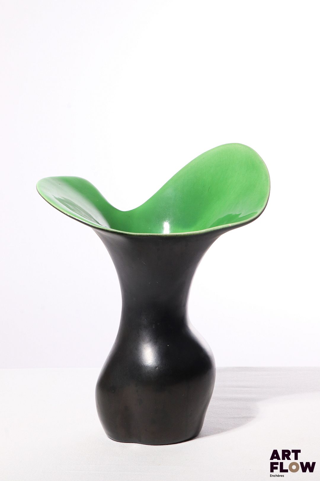 POL CHAMBOST (1906-1983) Vase 1040 dit "corolle" en faience émaillée à couverte noire à l'extérieur, verte à l'intérieur. Incisé au revers "Poterie Pol Chambost, 1040, Made in France" 30 x 23 x 16 cm Bibliographie : Philippe Chambost, "Pol Chambost, Sculpteur-Céramiste 1906-1983", Somogy Editions d'Art, Paris, 2006, p. 79