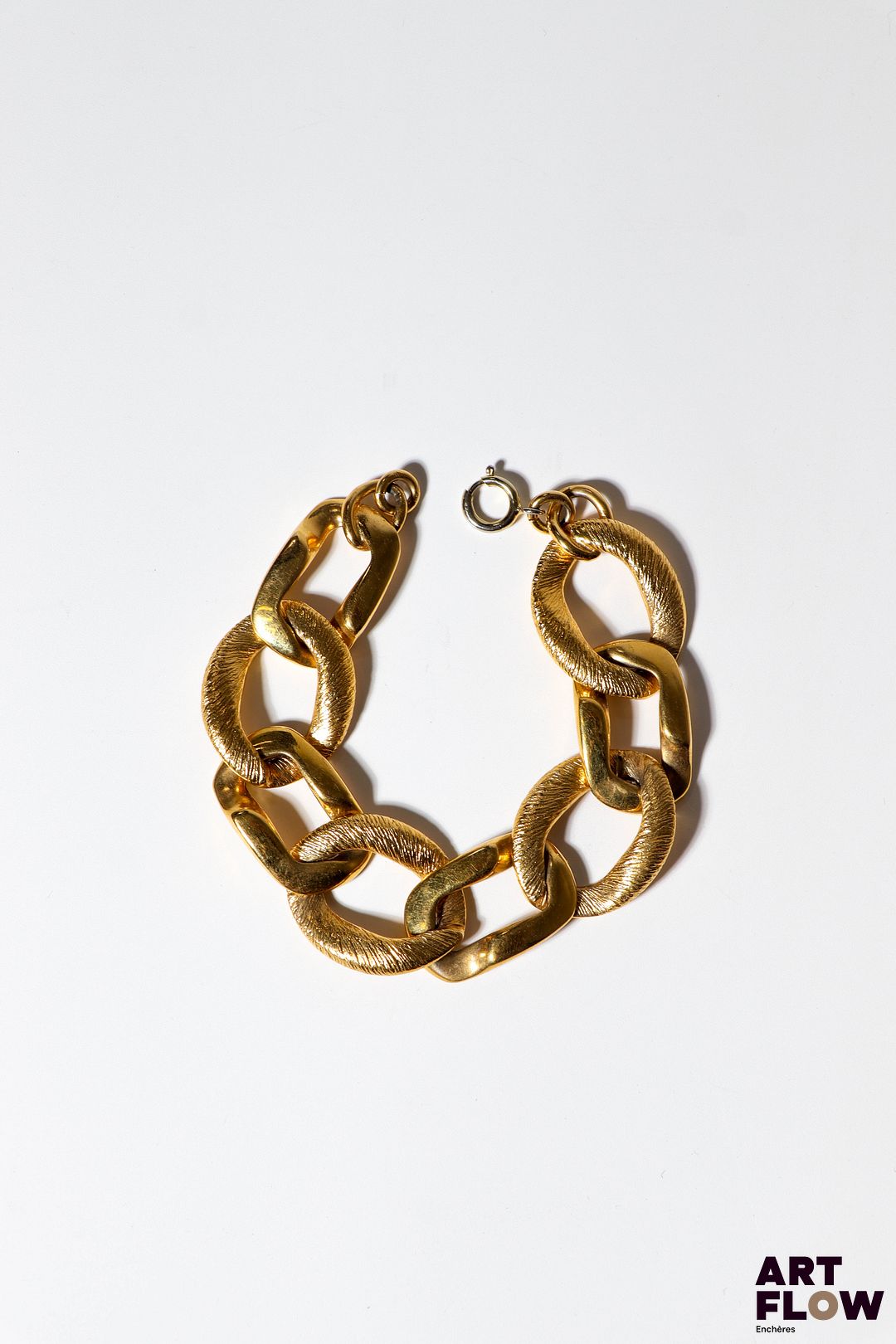 Goossens, prototype pour YVES SAINT LAURENT ? Bracelet à mailles alternées en métal doré, certaines lisses et d'autres à décor légèrement guilloché, à l'imitation de fils d'or. Non siglé. L. 20 cm env. Provenance : collection de la famille d'un ami et collaborateur de Robert Goossens.