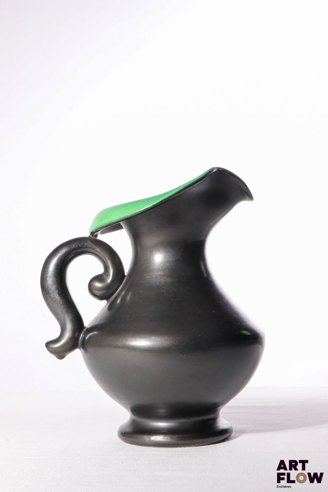 POL CHAMBOST (1906-1983) Pichet en faience émaillée à couverte noire, l'intérieur à couverte verte. Non signé - probablement pichet modèle 831. 25 x 20 x 16 cm env. Bibliographie : Philippe Chambost, "Pol Chambost, Sculpteur-Céramiste 1906-1983", Somogy Editions d'Art, Paris, 2006, modèle similaire p. 96