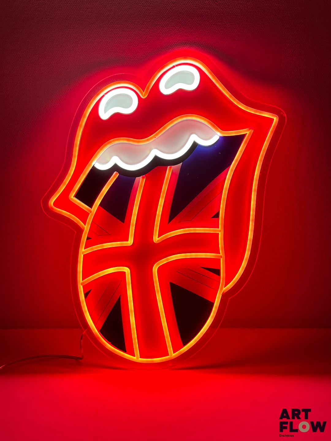 Enseigne lumineuse publicitaire sur plexiglas Rolling Stones. Dimensions : 54 x 43 cm Fonctionnelle - État général excellent. Fourni avec son alimentation murale.