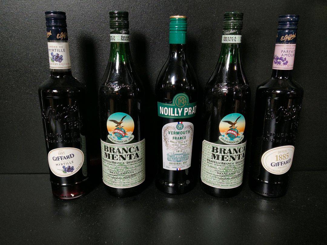 Lot de 9 bouteilles de spiritueux/apéritifs dont : Vermouth Noilly Prat, crème/liqueur Giffard, rhum arrangé Rivière du Mât Passion Hibiscus…
