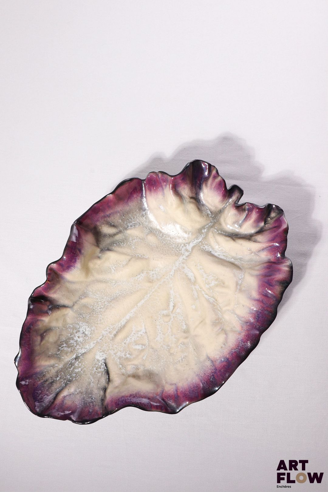 POL CHAMBOST (1906-1983) Importante coupe 6 en forme de feuille, en faience émaillée à couverte polychrome pour l'intérieure, noire à l'extérieur. Incisée au revers "Poterie Pol Chambost, Made in France, n°6" 43,5 x 31 x 10 cm Bibliographie : Philippe Chambost, "Pol Chambost, Sculpteur-Céramiste 1906-1983", Somogy Editions d'Art, Paris, 2006, modèle similaire p. 76