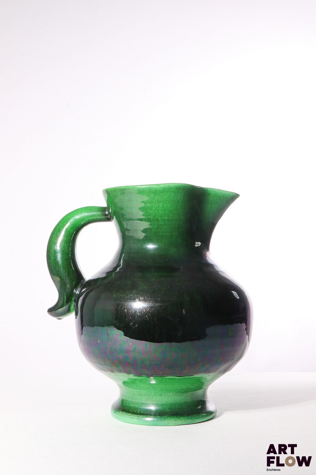 POL CHAMBOST (1906-1983) Pichet 820 en faience à couverte polychrome en dégradé vert et noir. Porte un cachet "820", et incisé "Made in France" 28 x 24 x 20 cm env. Bibliographie : Philippe Chambost, "Pol Chambost, Sculpteur-Céramiste 1906-1983", Somogy Editions d'Art, Paris, 2006, modèle similaire p. 55
