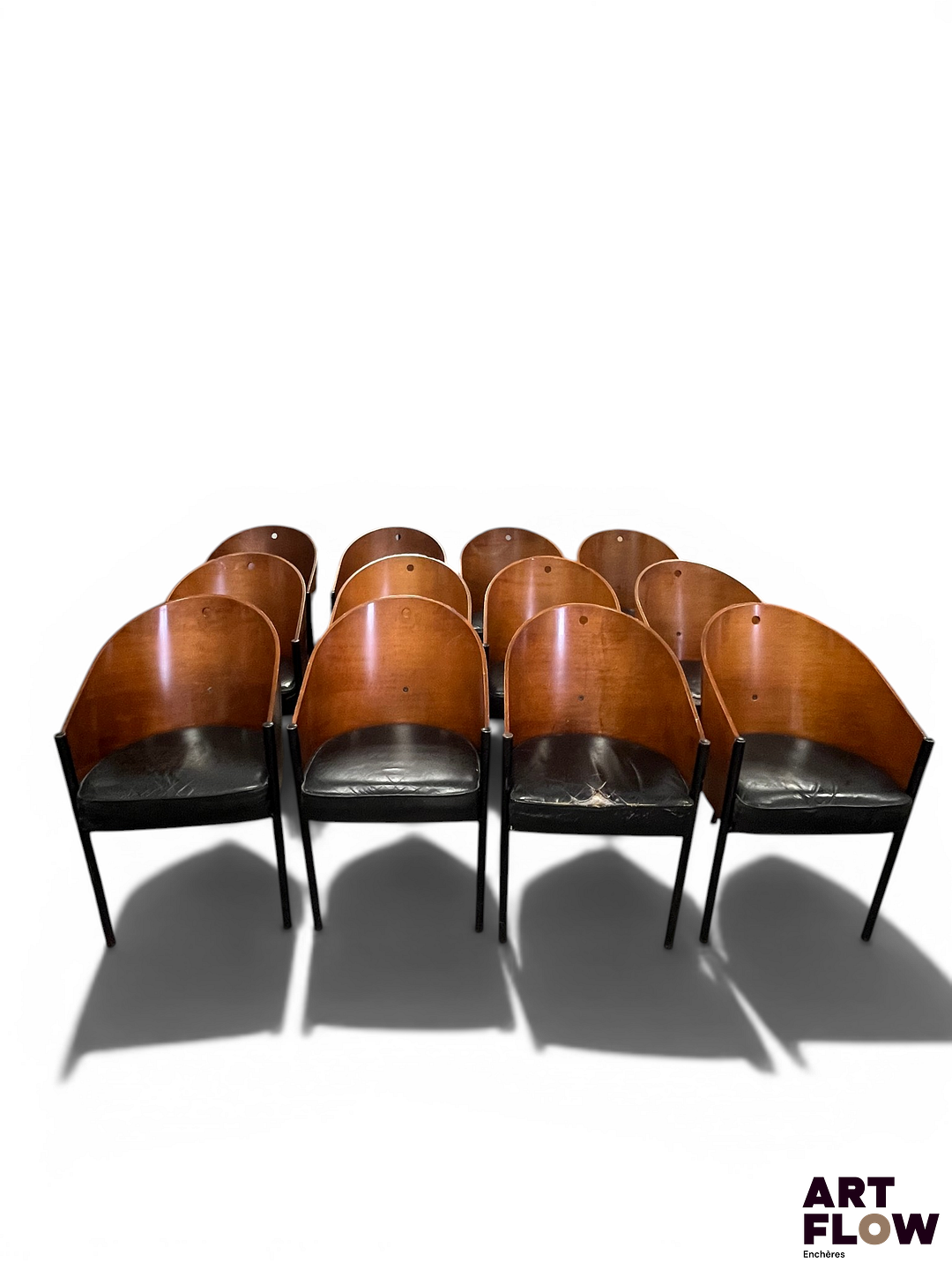 PHILIPPE STARCK POUR DRIADE Modèle COSTES Suite de 12 fauteuils en acier et bois, l'assise en cuir rembouré En l'état (accidents, manques)